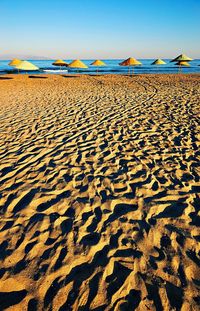 Scenic view of sand dune on beach against sky