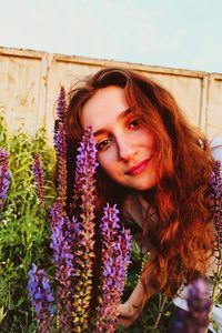 Portrait of beautiful woman with purple flower