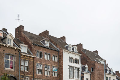 Low angle view of buildings in town against sky