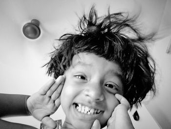 Low angle portrait of cheerful girl at home