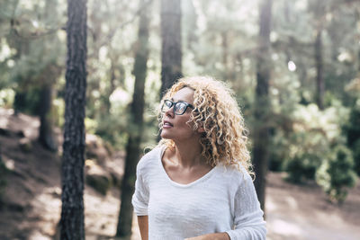 Thoughtful woman looking away at forest