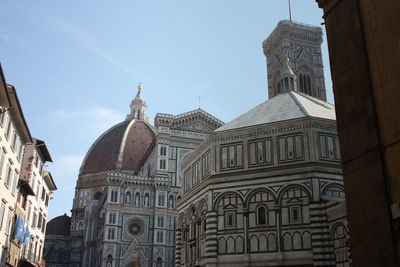 Low angle view of buildings in city against sky