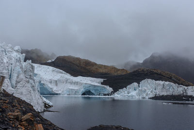 Scenic view of lake against sky during winter