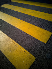 Yellow crossing sign on road