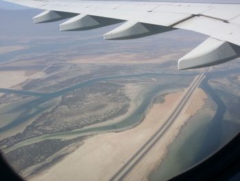 Aerial view of airplane wing over landscape