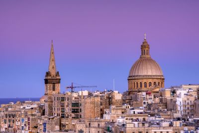 View of buildings in city against clear sky