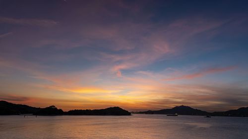 Scenic view of sea against romantic sky at sunset