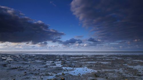 View of calm sea against cloudy sky