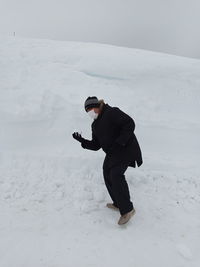 Full length of man standing on snow covered landscape during winter