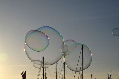 Low angle view of balloons against sky
