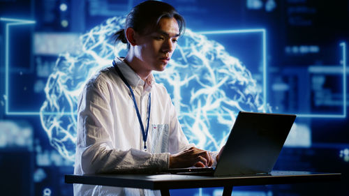 Businesswoman using laptop at office