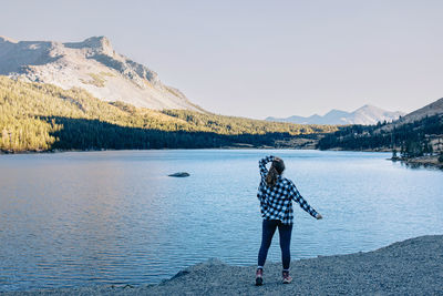 Rear view of woman standing in lake