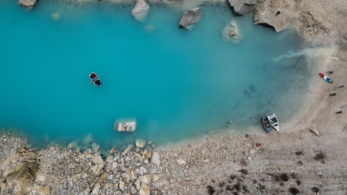 High angle view of people on rocks by sea