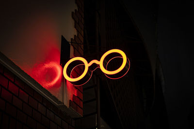 Low angle view of illuminated text on building at night