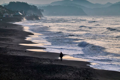 Scenic view of sea against mountain　during sunrise