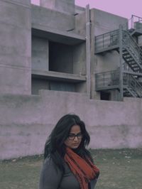 Portrait of woman standing in front of building