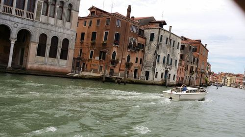 View of boats in sea against buildings