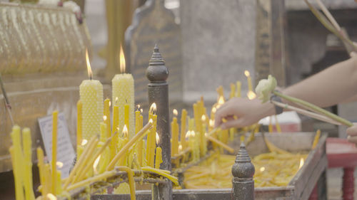 Close-up of hand against temple outside building