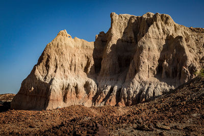 Panoramic view of rocky mountains against clear sky