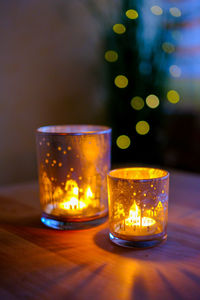 Close-up of illuminated tea light on table