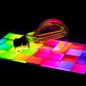 Close-up of illuminated lighting equipment against black background