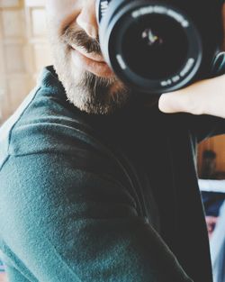 Midsection of man holding camera