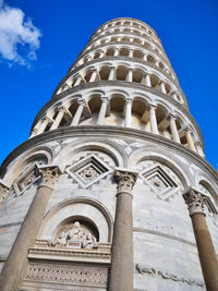 Low angle view of tower of pisa against blue sky