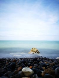 Rocks on beach against sky