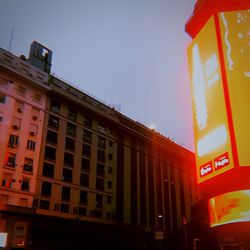 Low angle view of illuminated building against sky