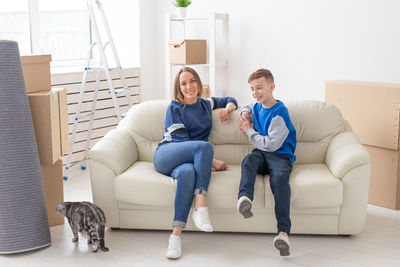 Young couple sitting on sofa at home