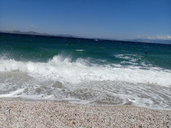 Scenic view of beach against blue sky