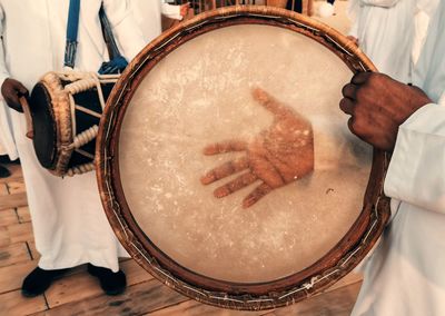 Cropped hand of man playing drum