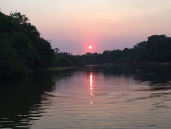 Scenic view of calm lake at sunset