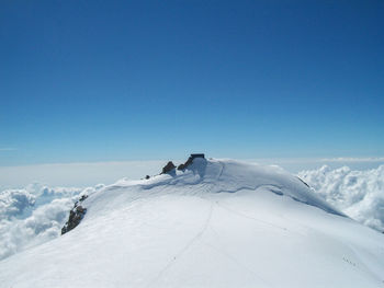 Scenic view of snowcapped mountains against clear blue sky