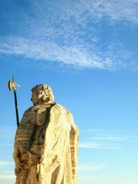 Low angle view of statue against clear blue sky