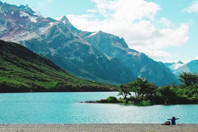 Scenic view of lake and mountains against sky