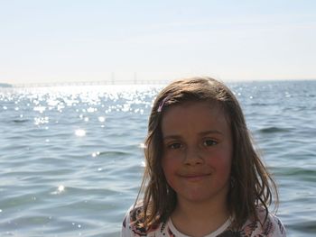 Portrait of smiling girl against sea