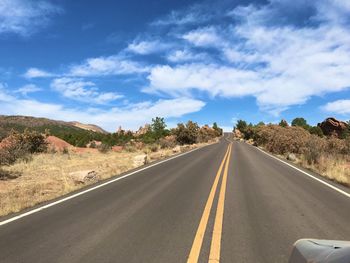 Empty road along countryside landscape