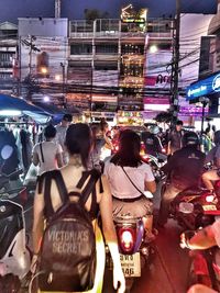 People on road in city at night