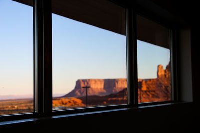 Landscape seen through window during sunset