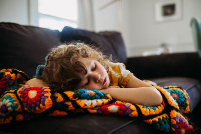 Young girl tired and sleeping on couch during the day