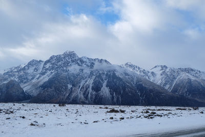 Scenic view of snow covered mountains against sky
