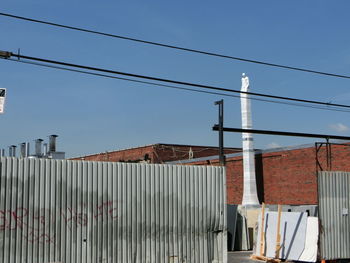 Low angle view of built structure against clear blue sky