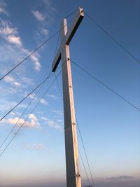 Low angle view of electricity pylon against sky