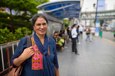 Portrait of woman standing outdoors