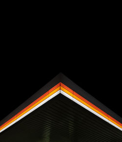 Low angle view of illuminated building against sky at night