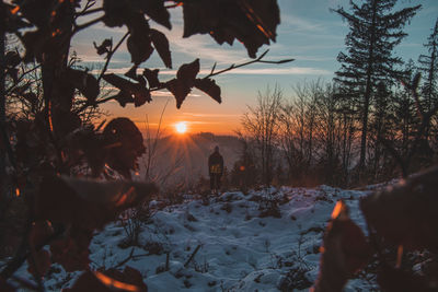 Scenic view of snow field against sky during sunset