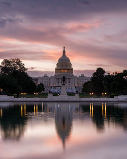 Reflection of building in lake at sunset