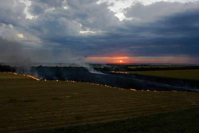 Scenic view of land against sky during sunset