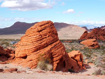 View of rocks on mountain against cloudy sky